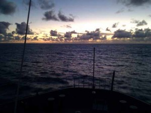 The endless sky and sea rolling under the front of the ship