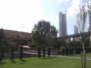 In this picture one of the remaining informal Gecekondu houses can be seen (left of the tree) wth the ultra-modern new housing developments towering in the background