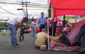 Outside the police cordon, more hunger strikers, now without food for several days, mingle with the media and other protesters